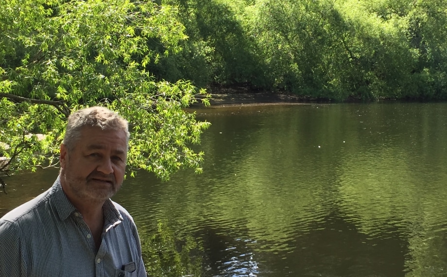 Icon patient John Patrick enjoying a sunny day near a lake.